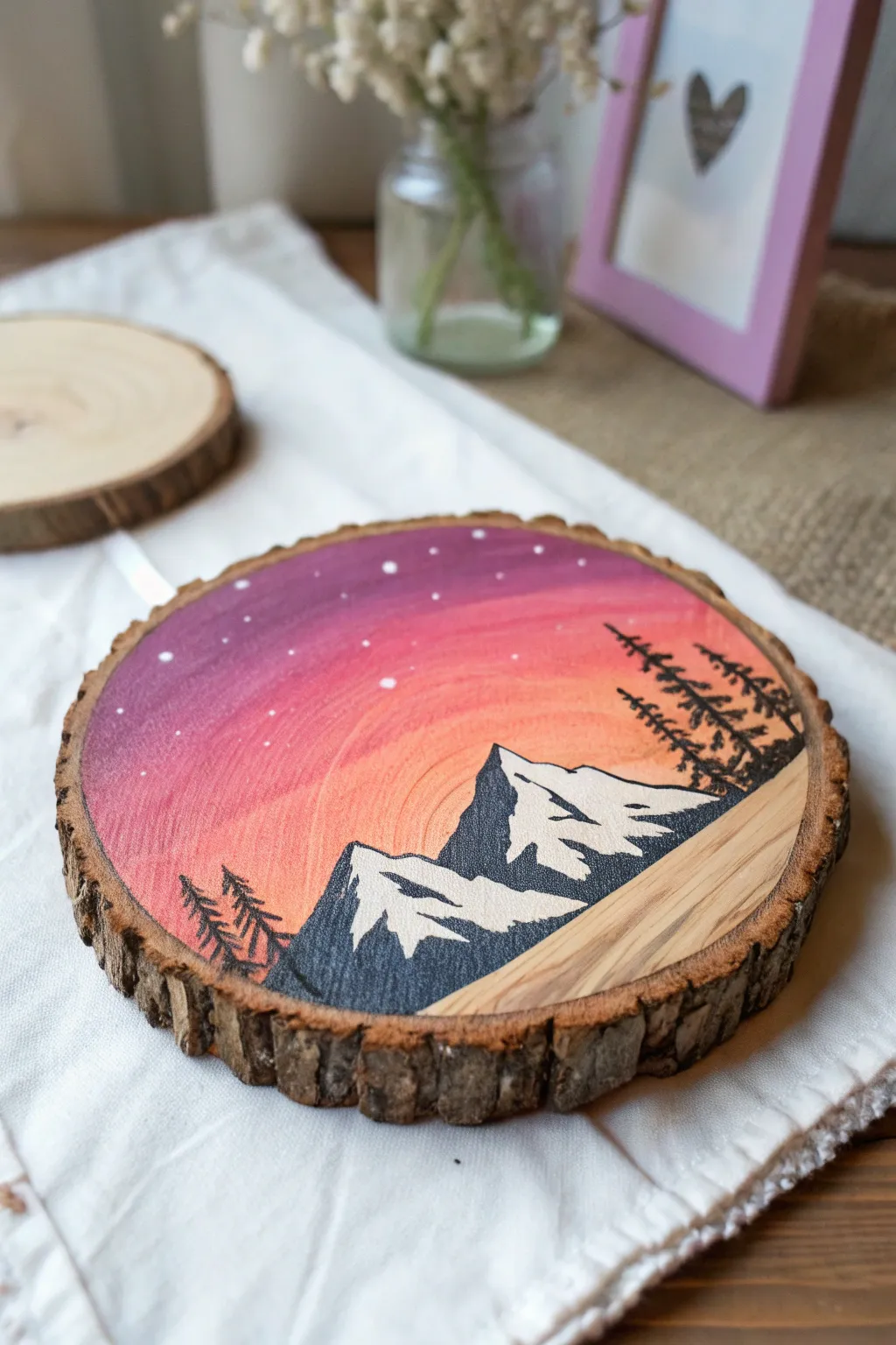 Mini mountain sunset painted in acrylic on a rustic wood round, crisp contrast and cozy boho minimalism