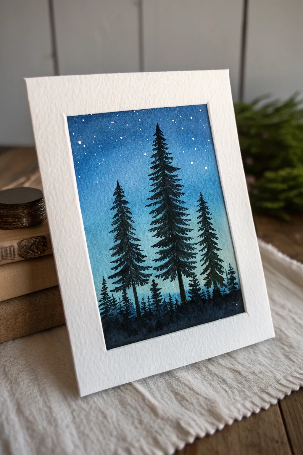 Black pine silhouettes meet a midnight blue gradient sky, simple Scandinavian-boho mood.