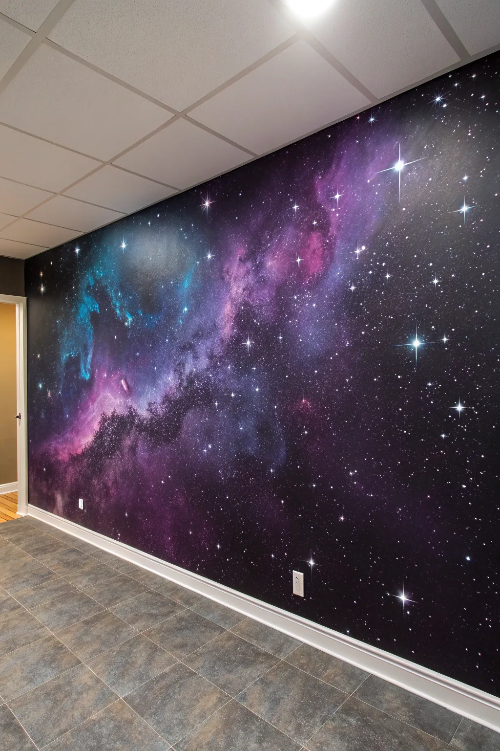 UV galaxy mural with glowing constellations and dreamy nebula swirls on a deep black wall