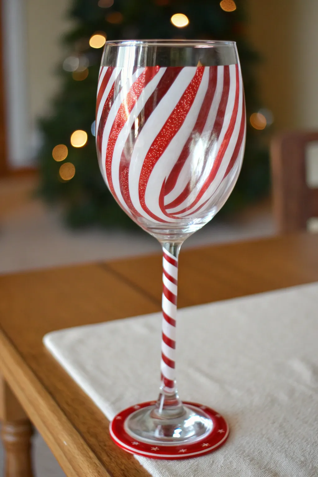 Candy cane stripes that spiral from stem to base, a chic minimalist Christmas glass idea