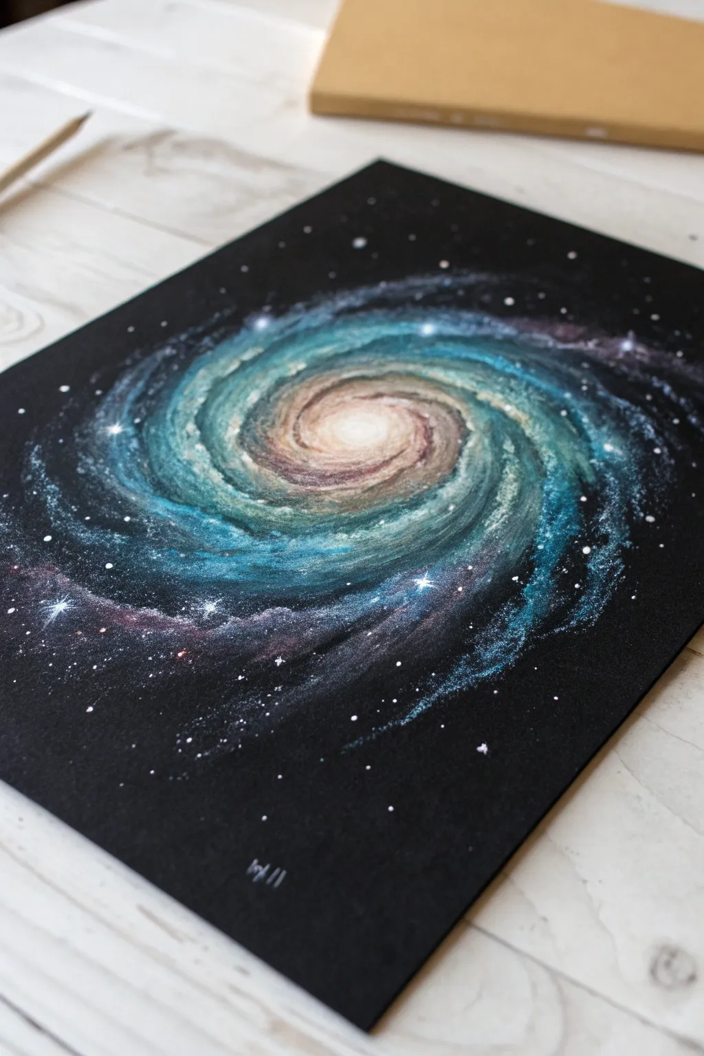 Galaxy spiral in colored pencil on black paper, luminous blues and violets with crisp star specks
