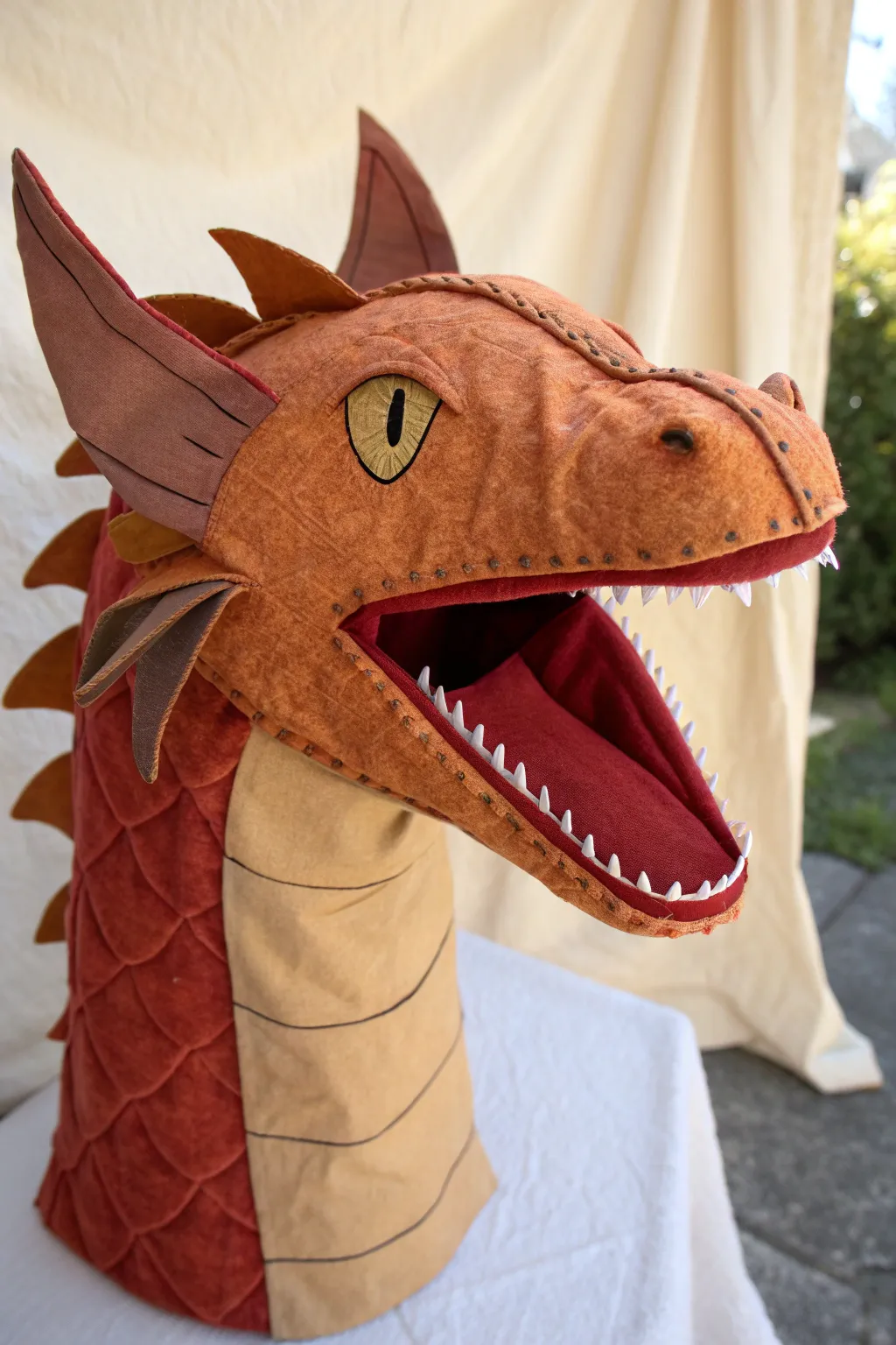 Inside view of a dragon puppet head showing clear thumb and finger pocket grip base design