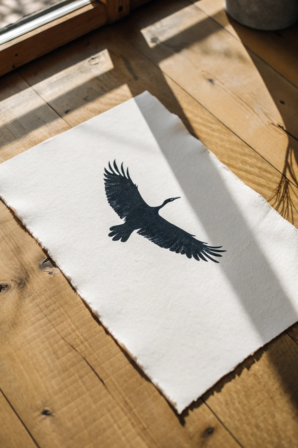 Minimal ink bird in flight with outstretched wings, clean silhouette and soft shadow contrast