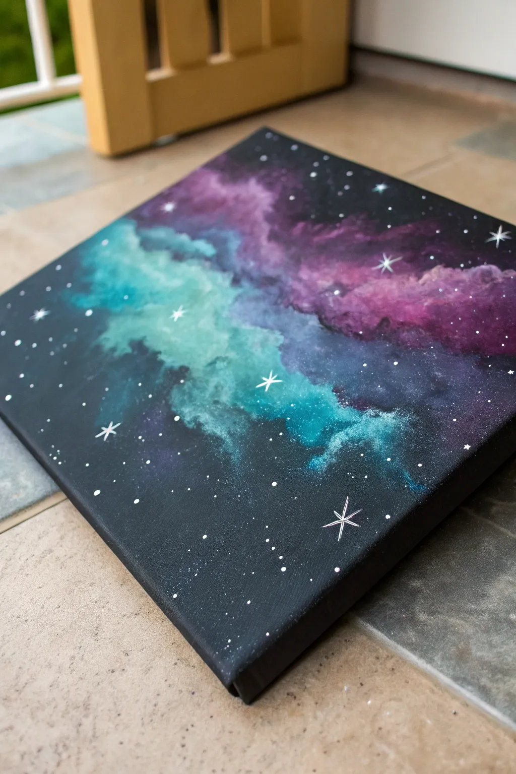 Soft sponge-blended galaxy glow on black canvas, framed by deep darkness and starry splatter