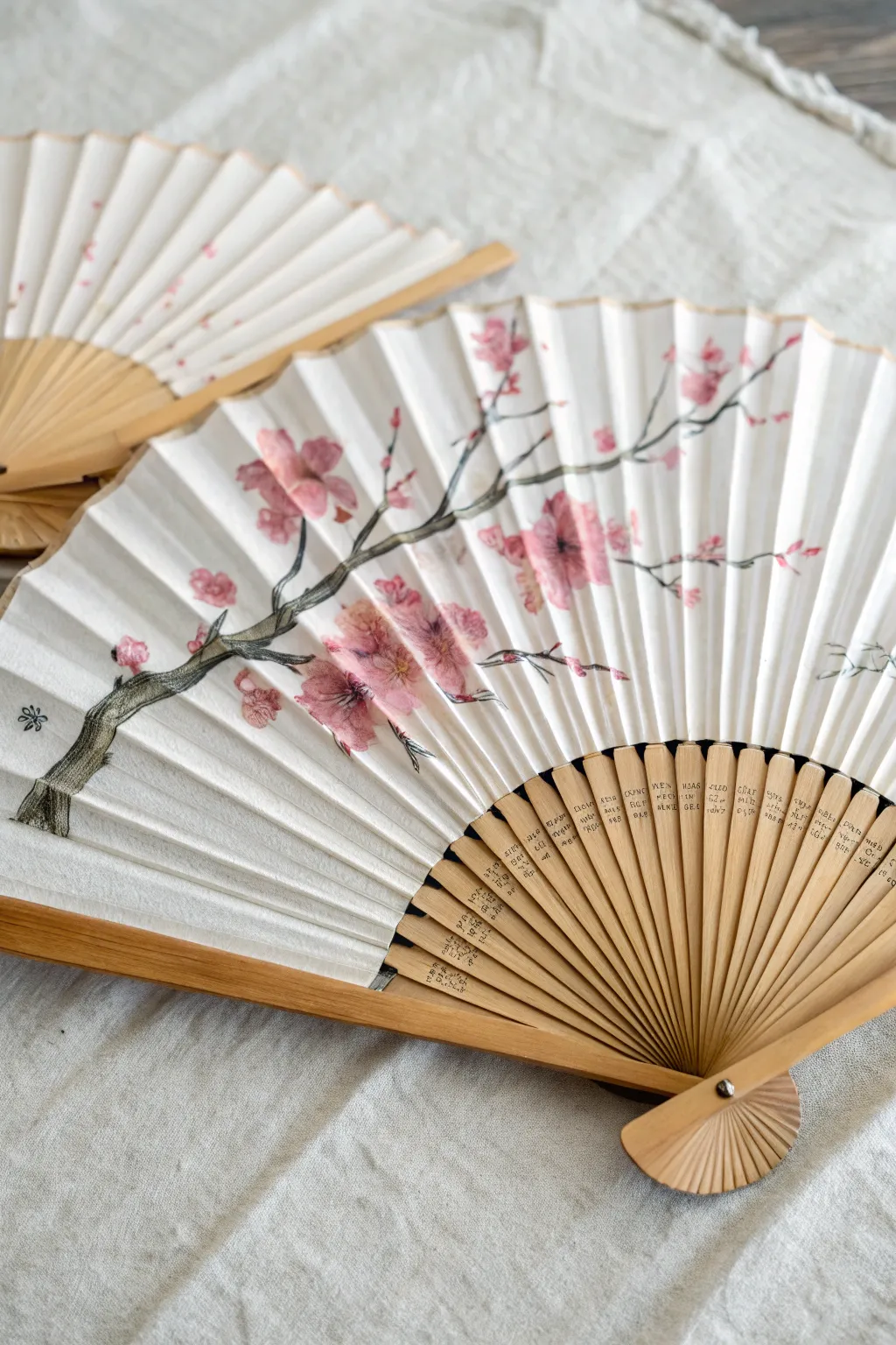 Paint cherry blossoms that hop across fan ribs for a delicate, airy spring effect.