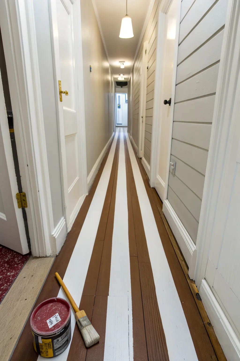 Bold stripes that lengthen your hallway, an easy DIY with tape and a steady brush.