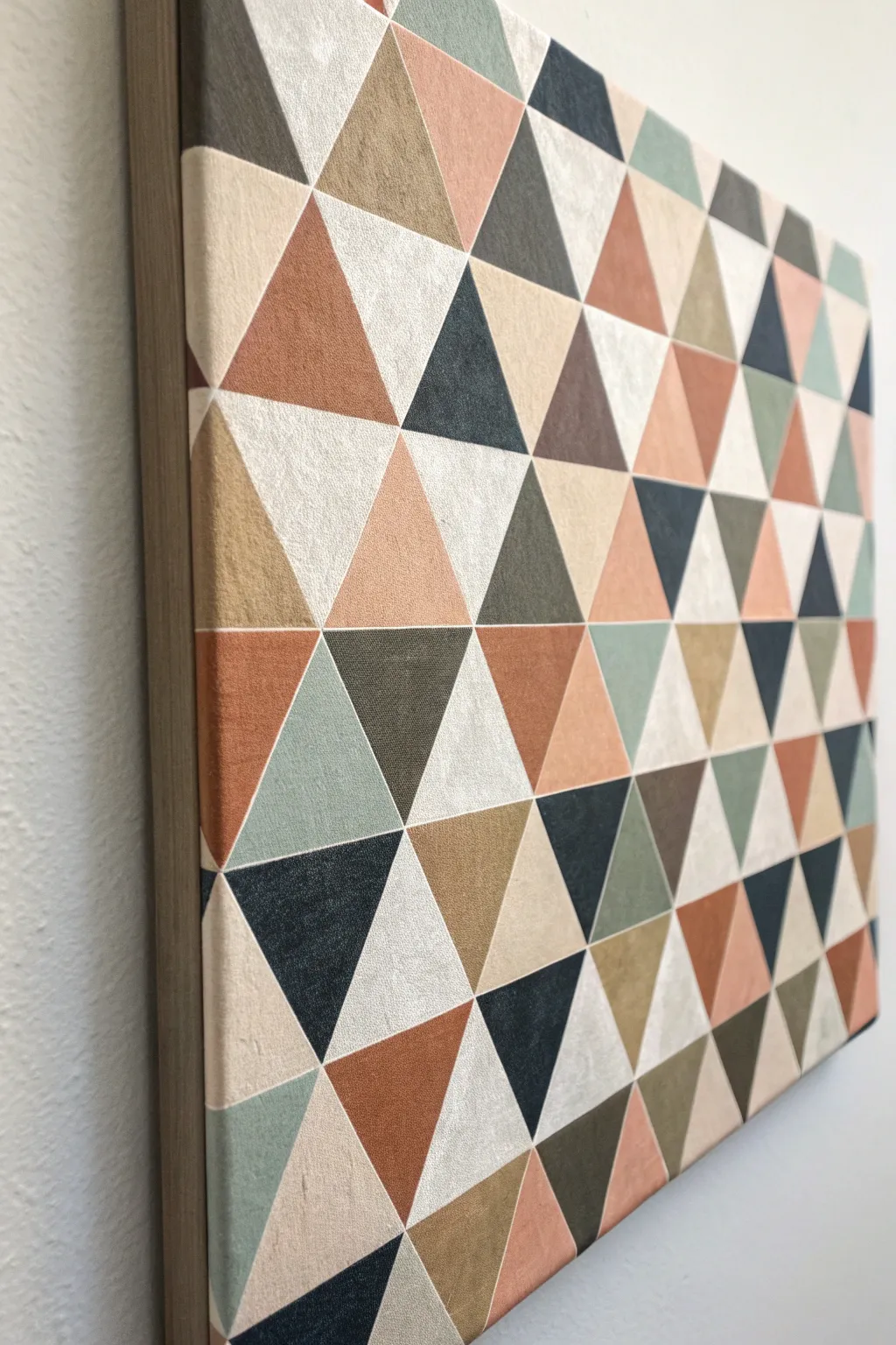 Tessellating triangles in soft boho neutrals form a calm faceted mosaic with subtle depth.