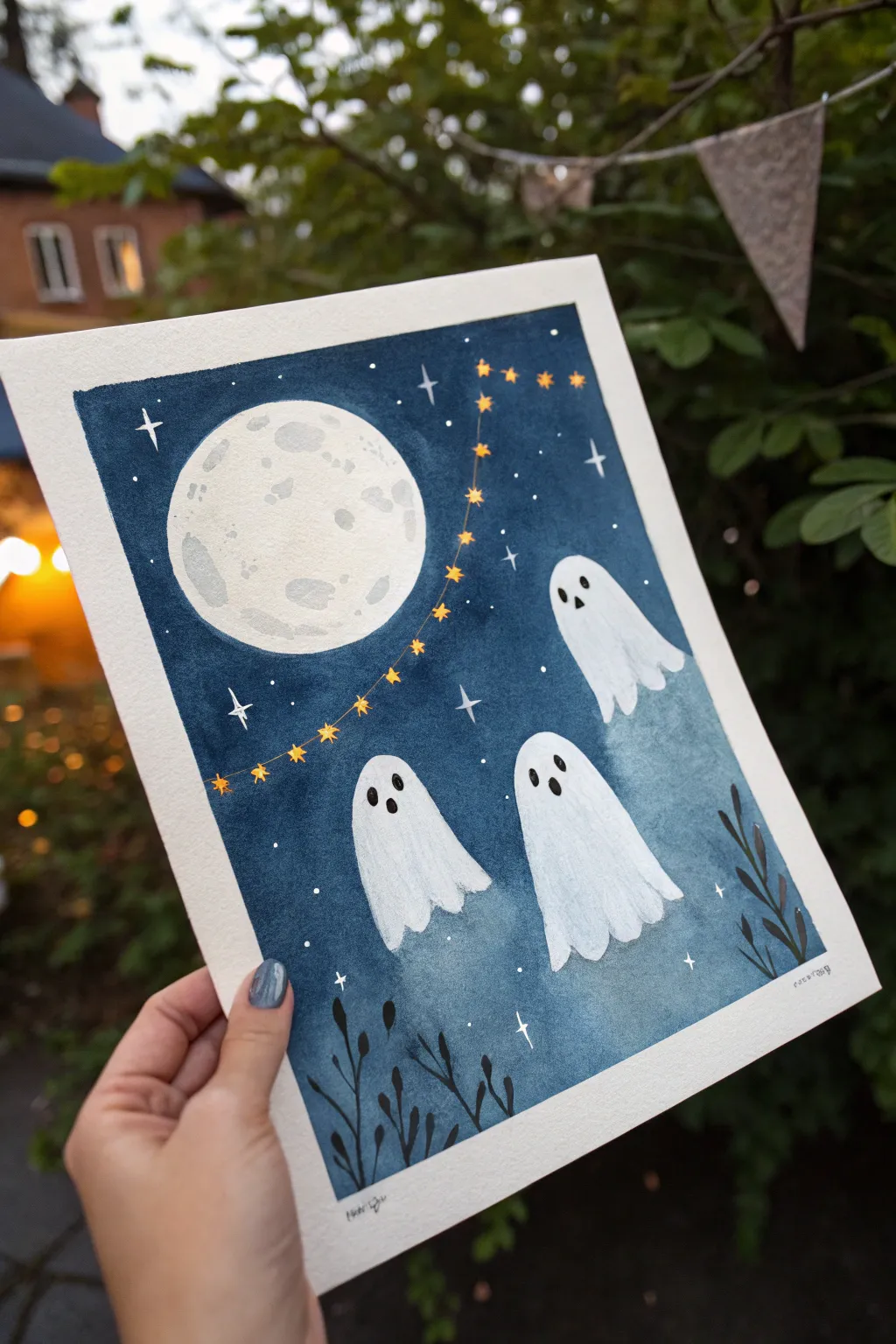 Minimal watercolor ghosts float through moonlight on an indigo sky, a cute high-contrast Halloween idea