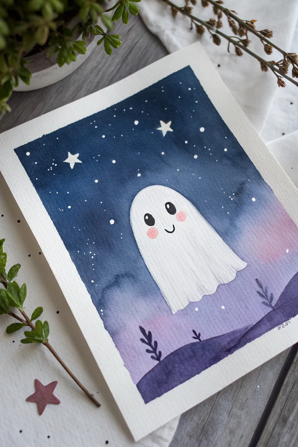 Friendly little ghost watercolor on a deep night sky wash, perfect kid-friendly Halloween art.