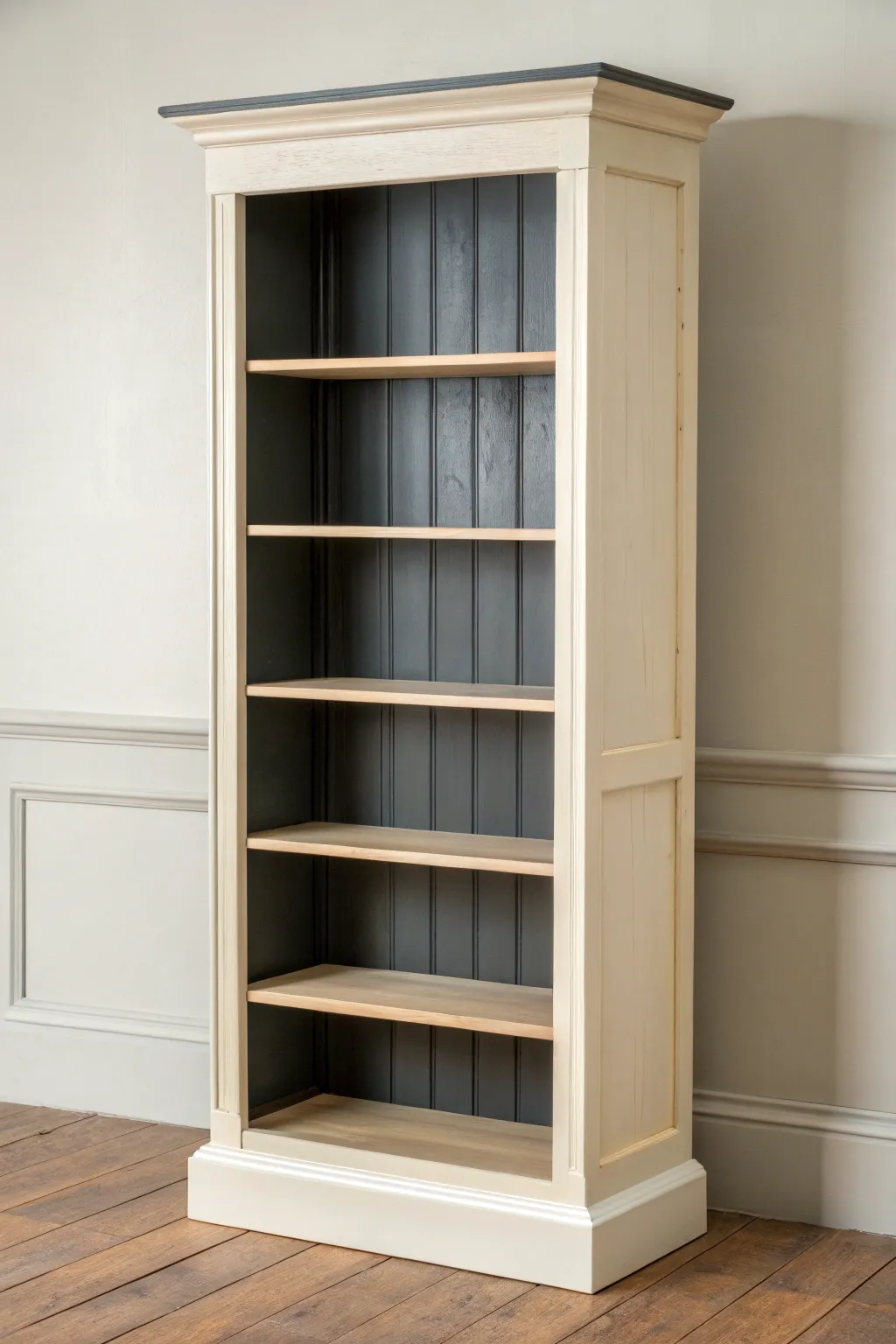 Two-tone hand painted bookcase with a light frame and dark interior for striking depth