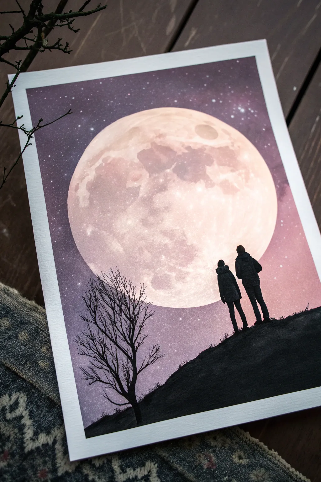 Create a moonlit silhouette scene: bold black figures, a glowing full moon, and a dreamy gradient sky.