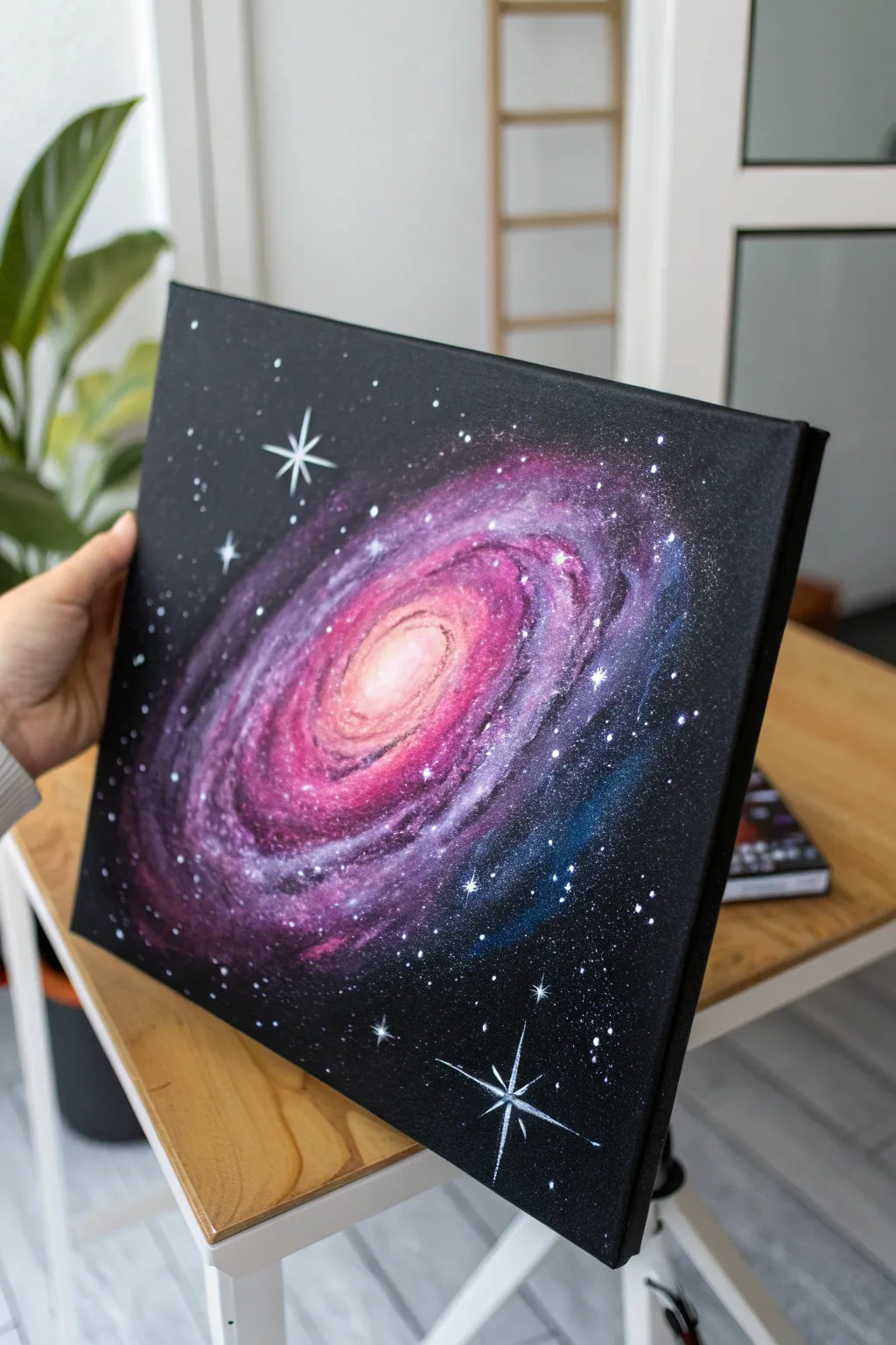 Neon galaxy on black canvas with a luminous core and delicate starfield spatter