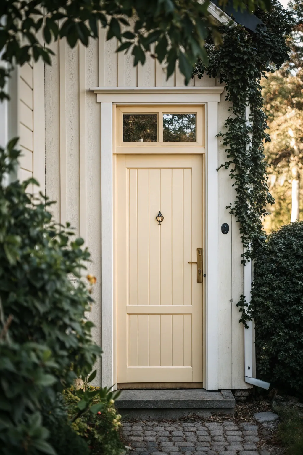 Warm cream exterior door with soft white trim, timeless contrast for outdoor paint inspiration.
