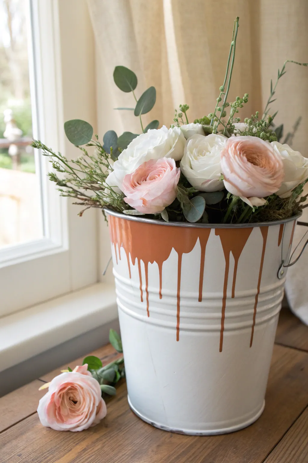 Minimalist paint-bucket planter with glossy drip rim and soft blooms, easy boho craft.