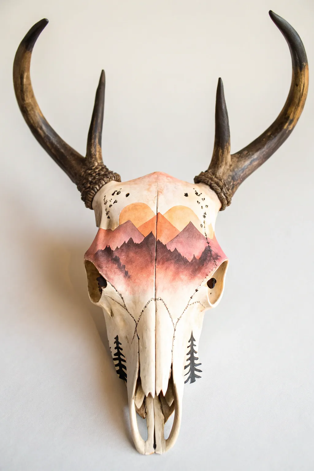 Warm sunset gradient and mountain silhouettes turn a deer skull into minimalist boho art.