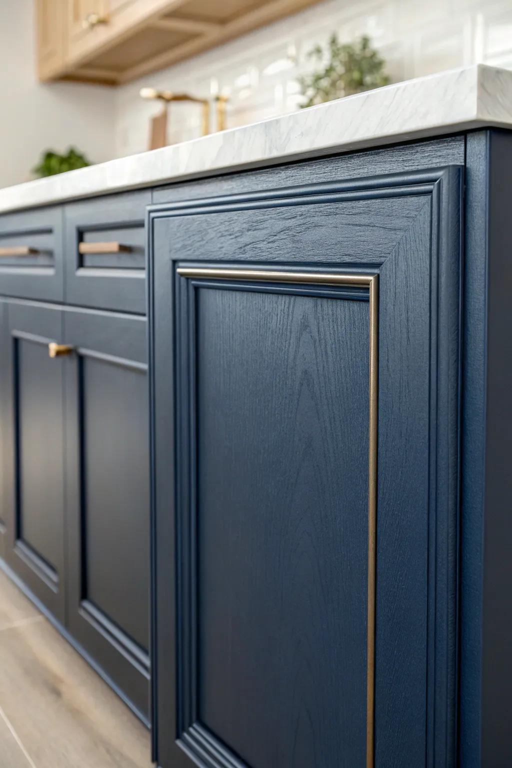 Navy cabinet front with crisp pale backsplash and light counters for clean, rich contrast.
