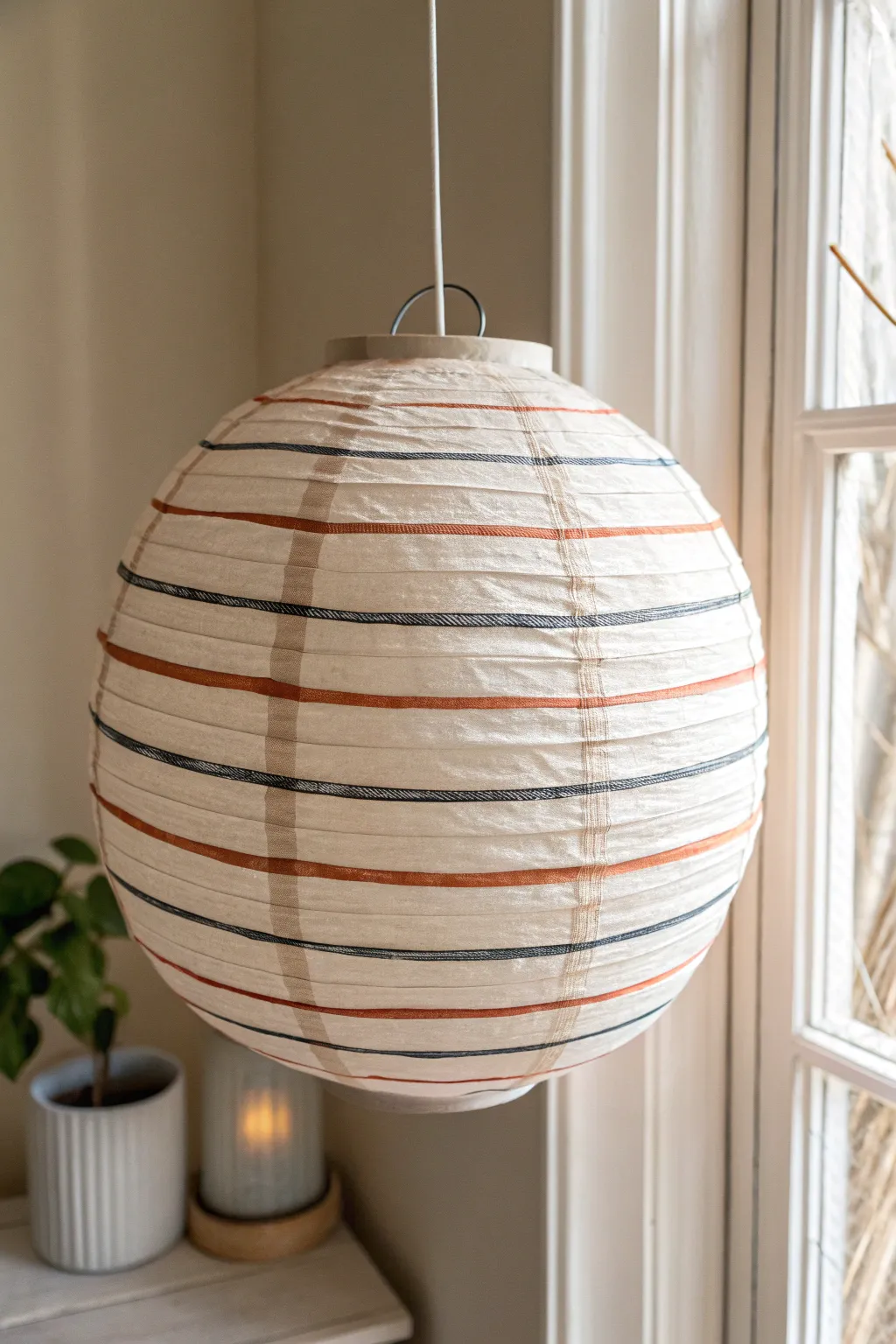 Classic horizontal stripes on a ribbed paper lantern for simple, modern boho painting inspiration.