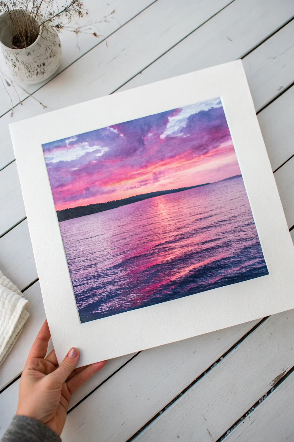 Dreamy pink and purple seascape painting with magenta reflections and a glowing horizon.