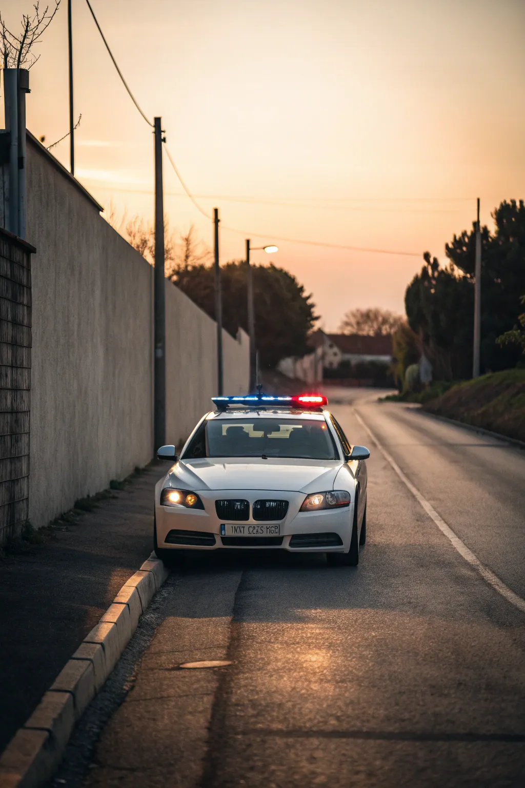 Patrol car in warm golden-hour light with soft reflections and a gentle blue-red glow