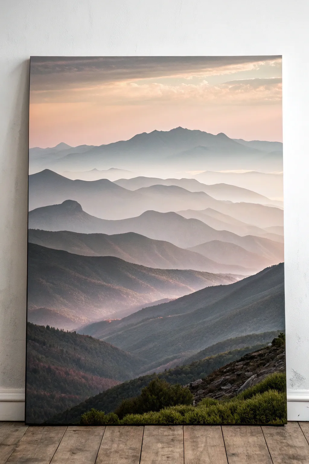 Layered mountain silhouettes on a rectangle canvas, fading into soft mist for calm contrast