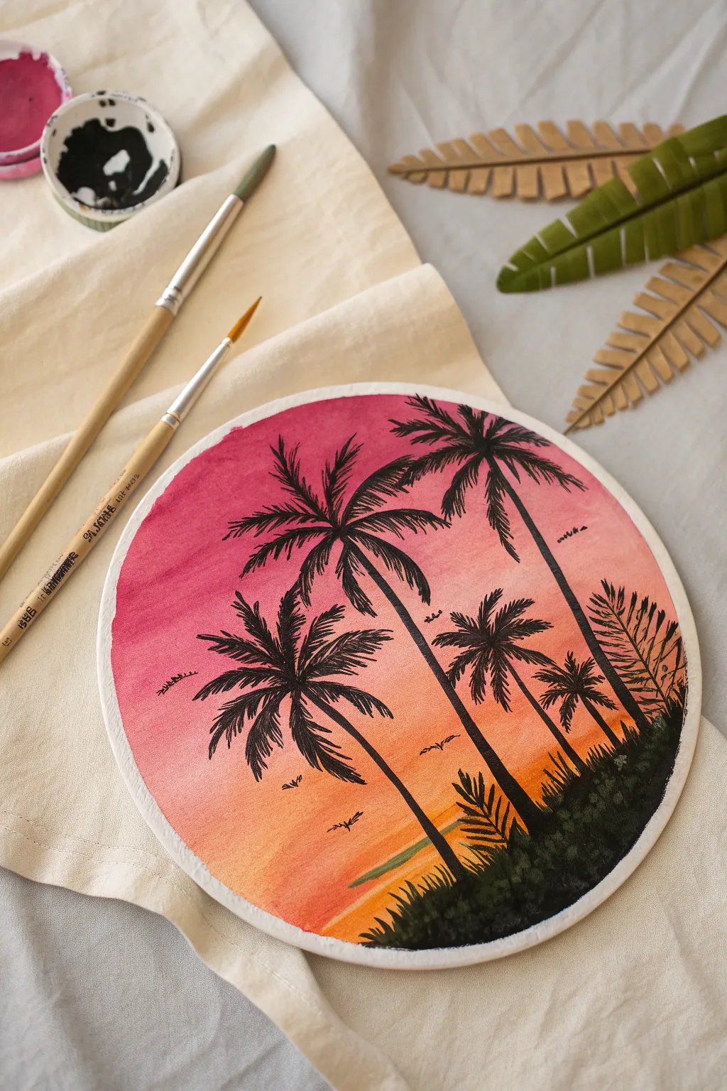 Bring tropical vibes home with this vibrant sunset and palm tree circle painting idea.