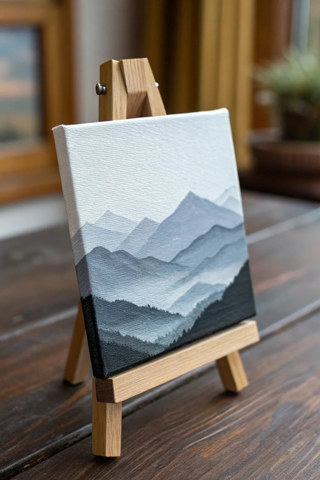 Tiny layered mountains in mist on a mini canvas, simple strokes and soothing minimalist contrast