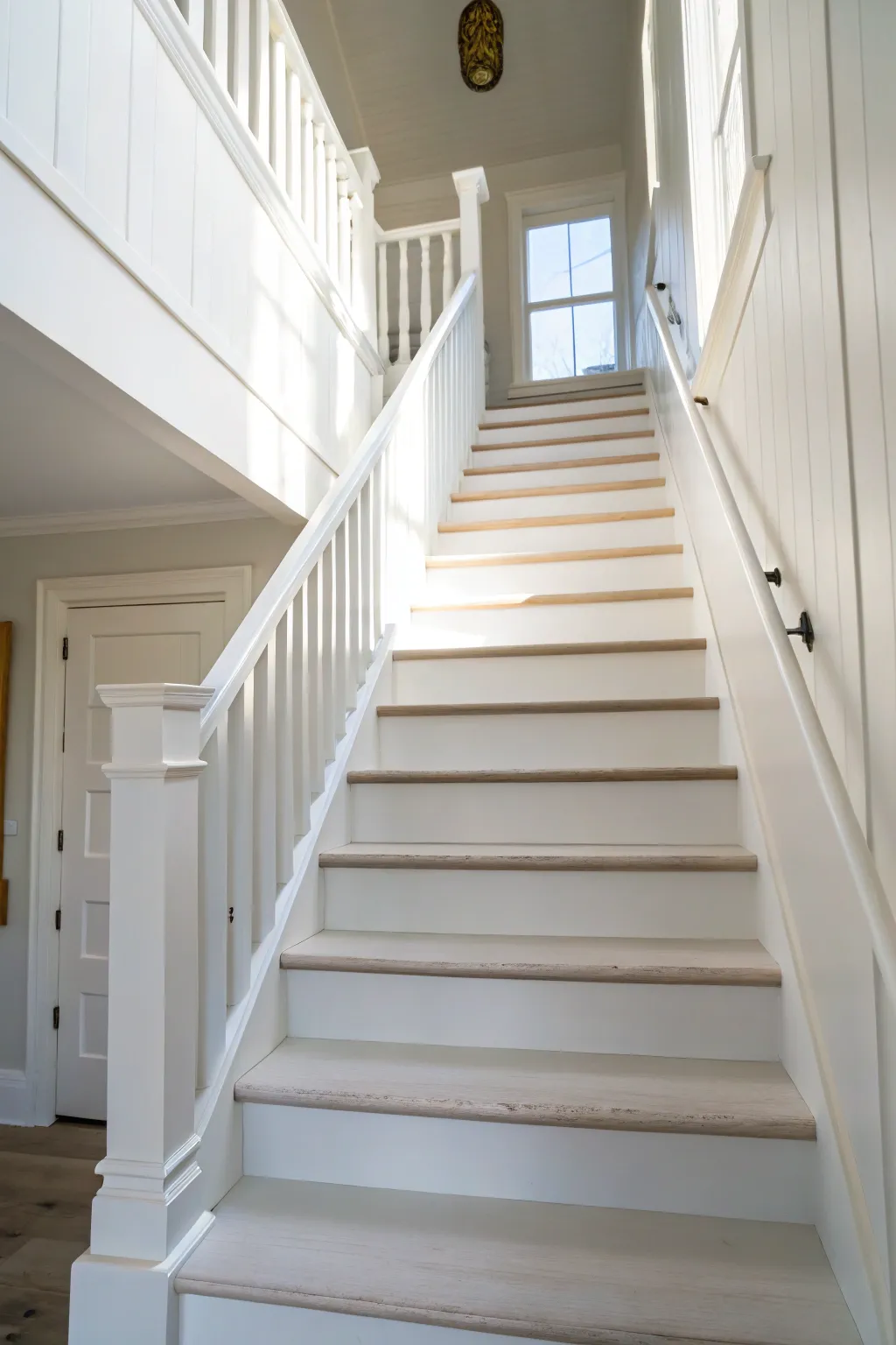 All-white stairs washed in morning light, a clean minimalist refresh with soft boho warmth.