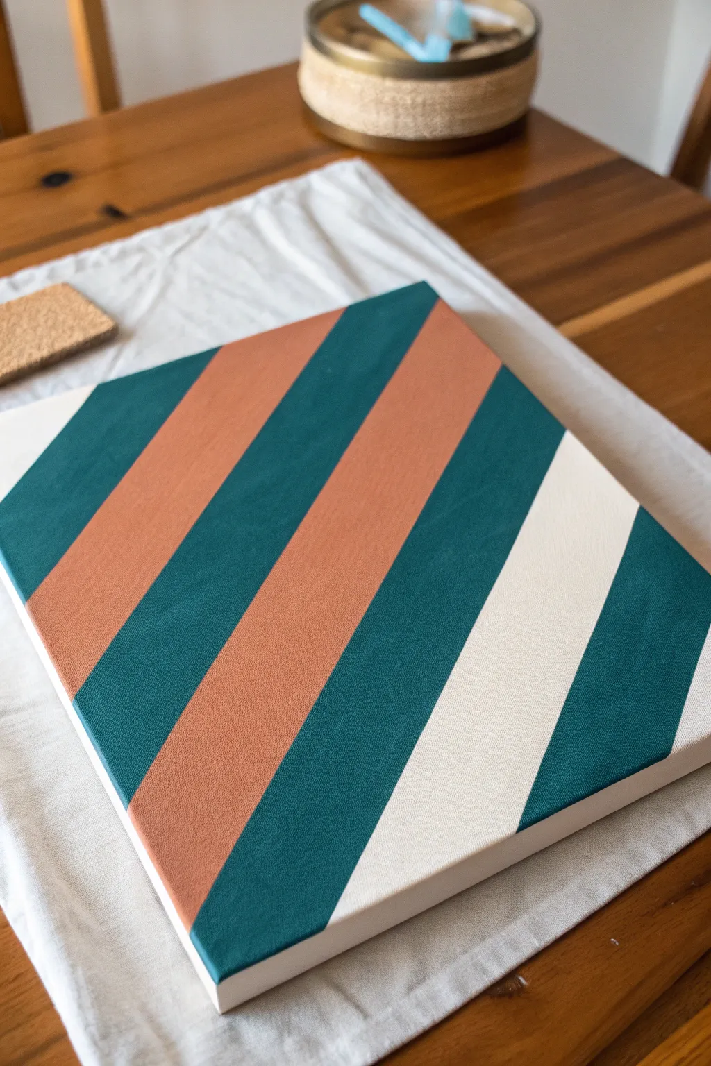 Two-color diagonal tape stripes, straight-on and crisp, with one corner of tape left on to show the process.