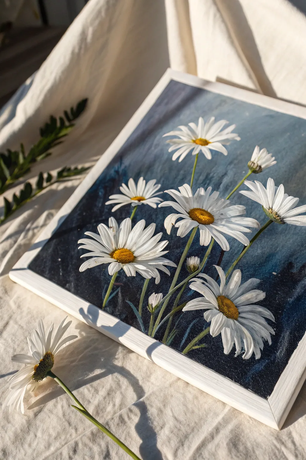 Bold white daisies with warm centers stand out beautifully against a moody charcoal background