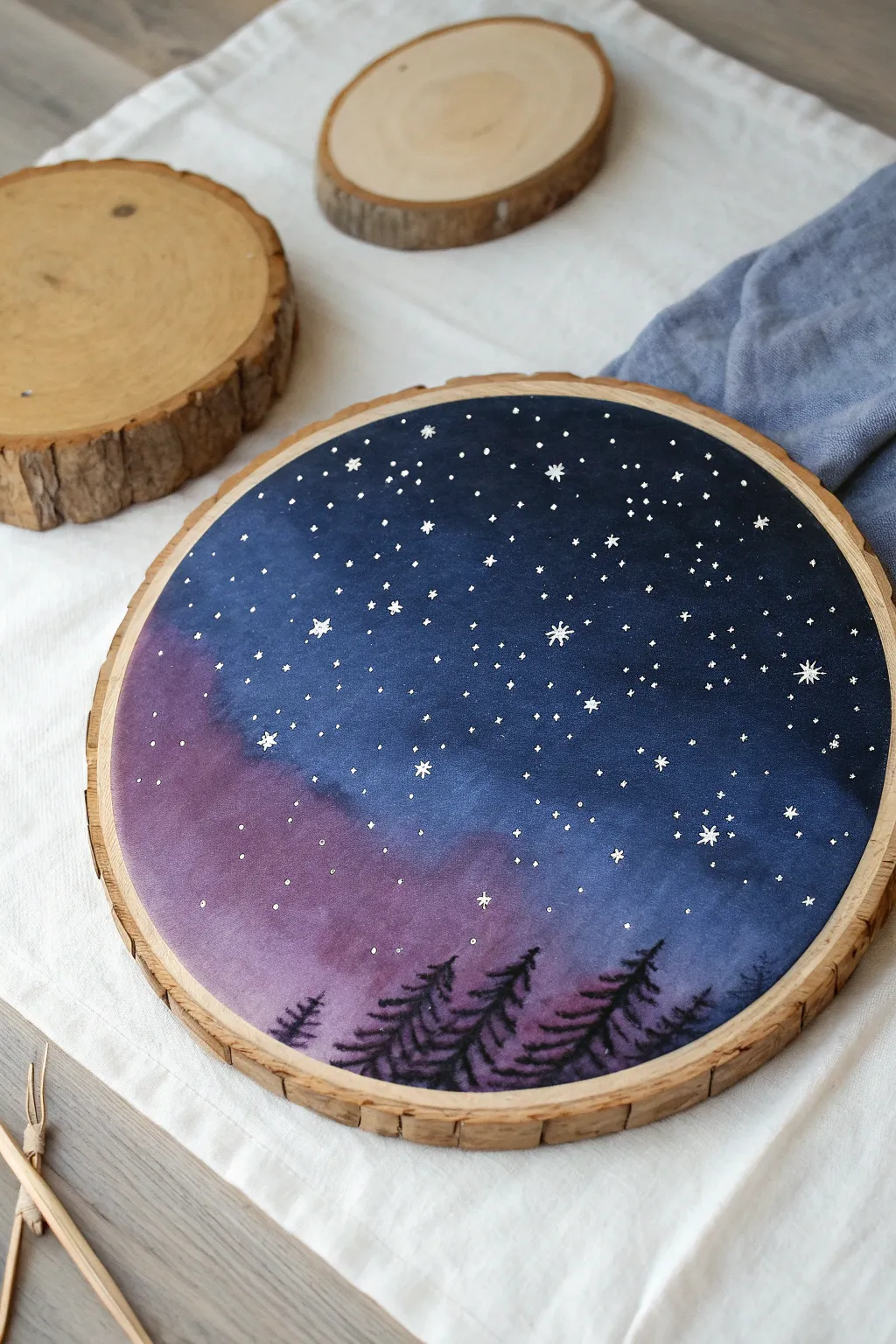 Starry galaxy on a wood round with milky haze, minimalist boho styling for easy DIY inspiration