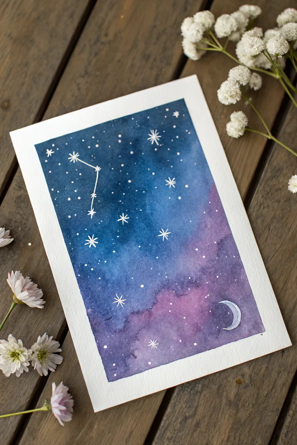Paint a salt-sparkle galaxy wash with dreamy blues, tiny stars, and a simple crescent moon.