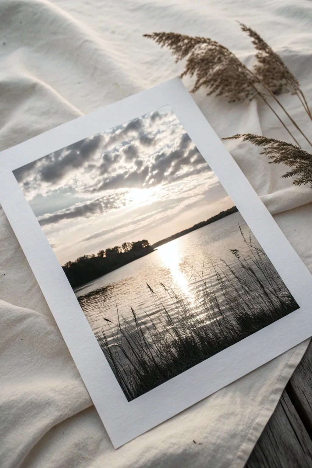 Minimal monochrome ink wash lake study, soft misty gradients and reed strokes, calm and modern.