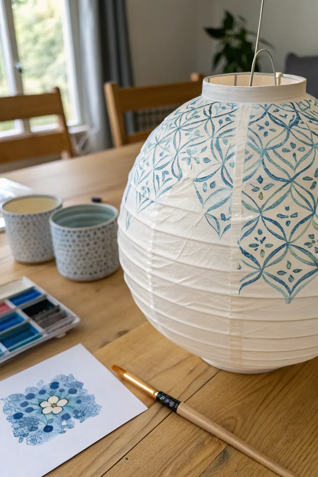 Wax resist secrets: bright patterns emerge as a soft watercolor wash flows over the lantern.