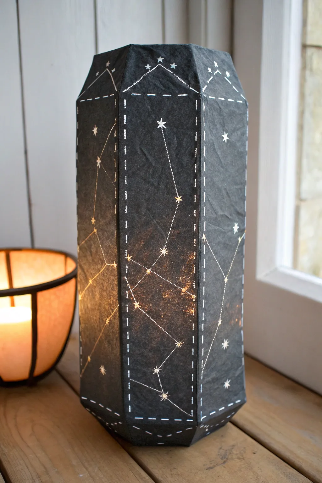 Glowing constellation paper mache lantern in minimalist boho styling, warm light and crisp details