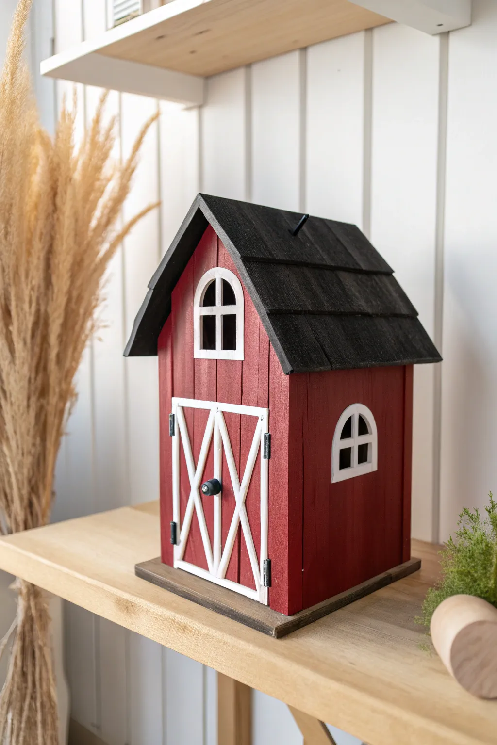 Add rustic charm to your garden sanctuary with this classic red barn birdhouse design.