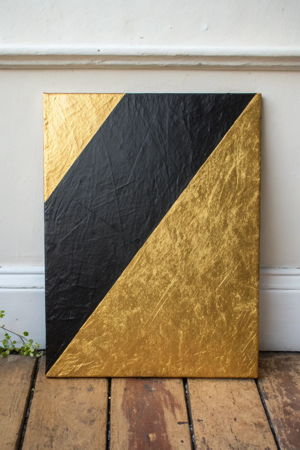 Striking diagonal split canvas: velvety black meets luminous metallic gold with a textured seam.
