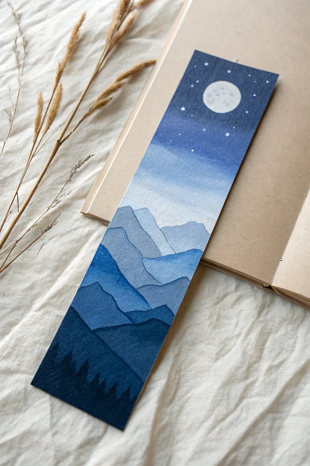 Moonlit layered mountains in calming blues, a simple acrylic bookmark idea with bold contrast.
