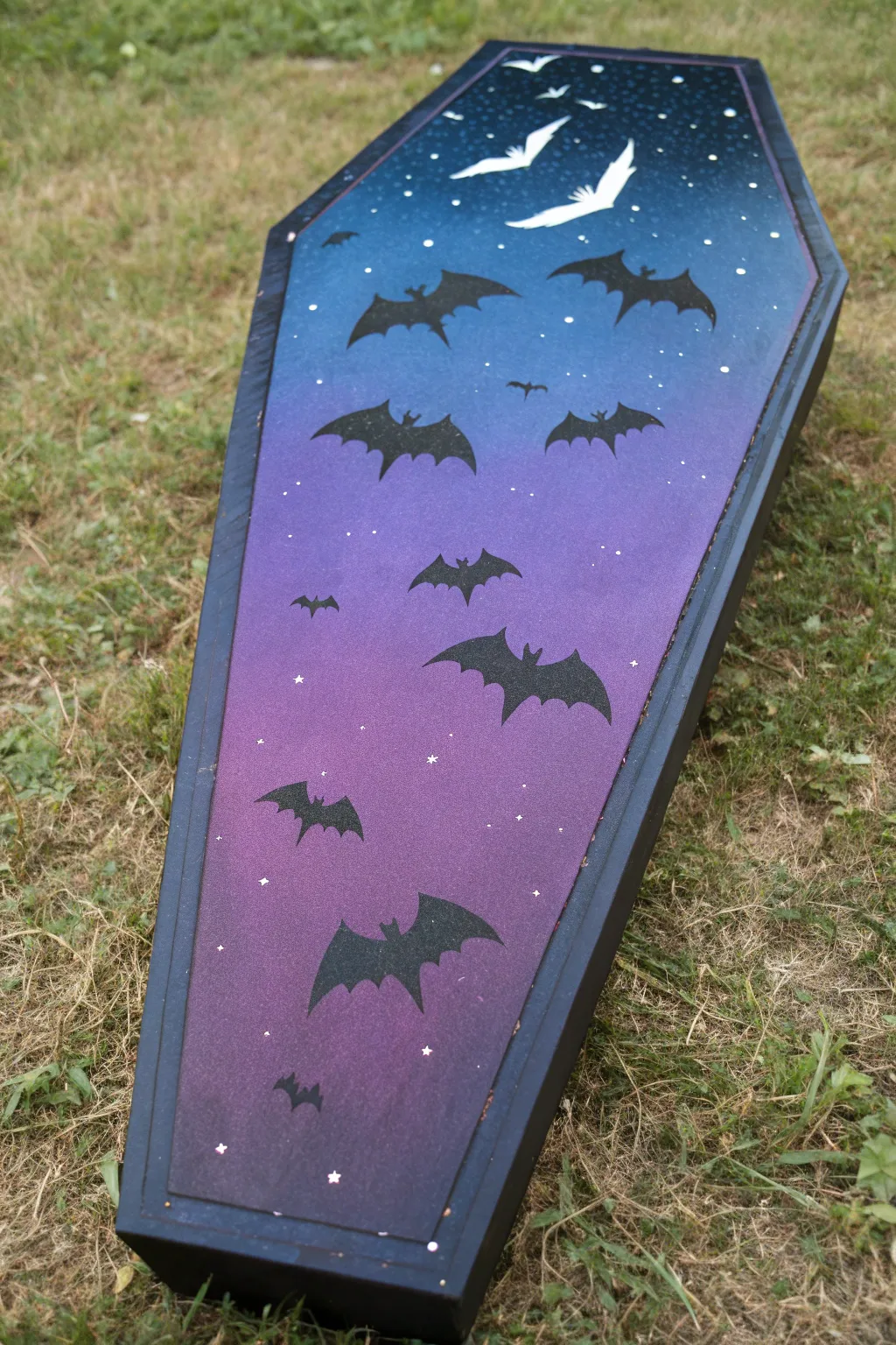 Twilight coffin lid gradient with bold bat silhouettes and delicate star speckles for moody contrast