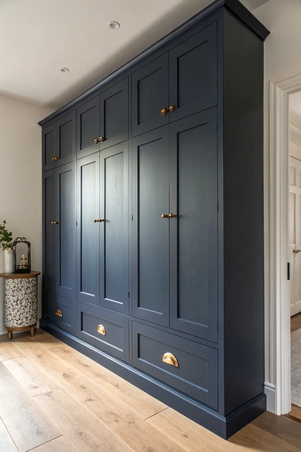 Deep navy cupboards with warm brass pulls for a bold, cozy Scandinavian statement.