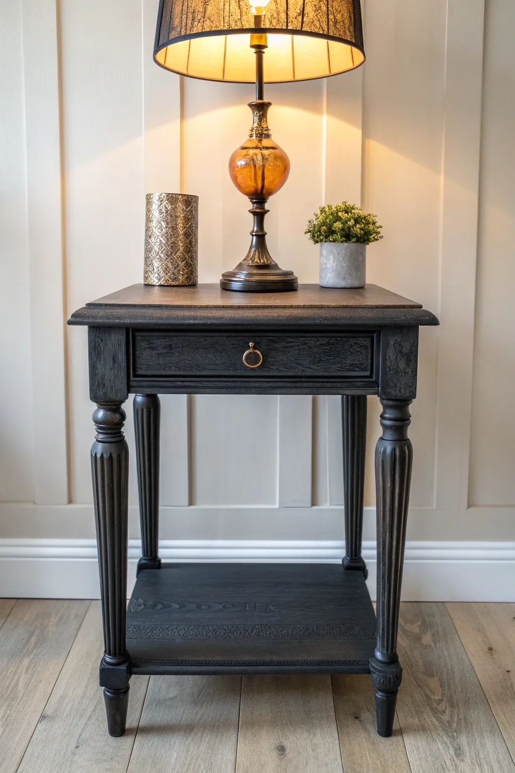 Moody inky end table paint with warm lamp glow for chic minimalist boho vibes in your nook.