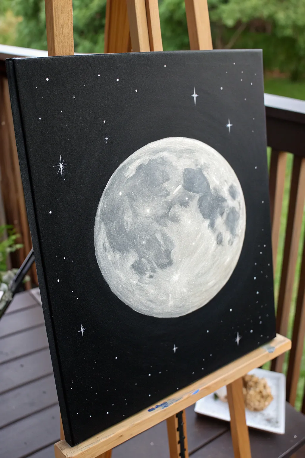 Minimal black canvas moon painting: glowing full moon halo with a few delicate stars to try.