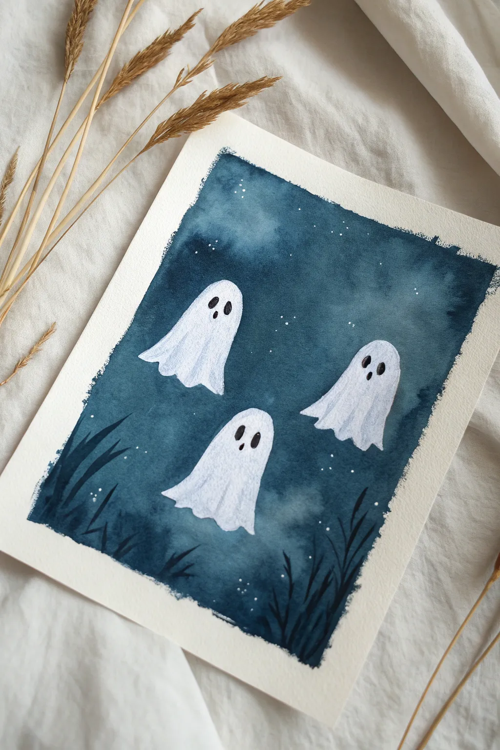 Minimal floating sheet ghosts on deep navy, a simple Halloween painting with soft misty strokes