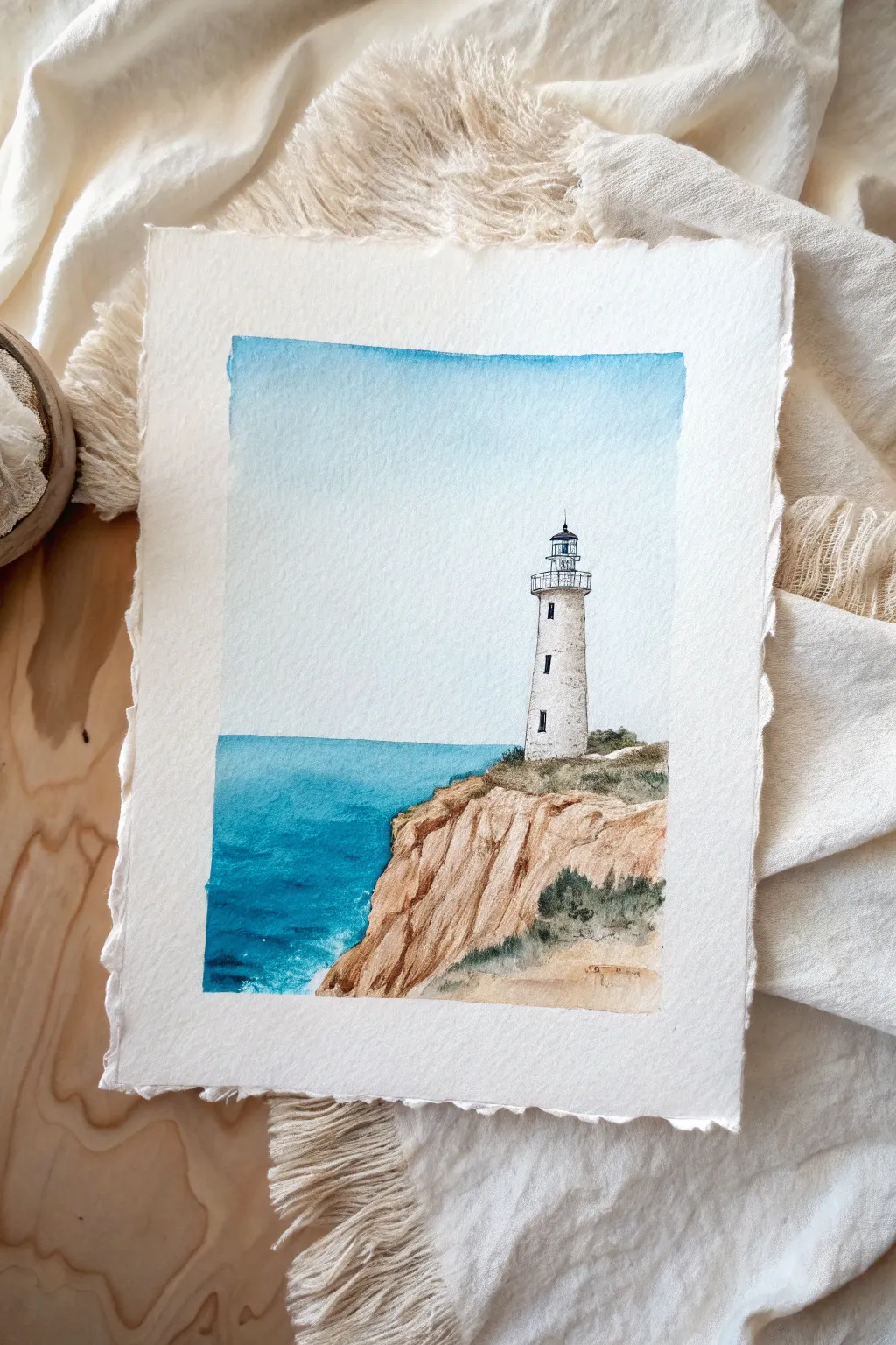 Minimal lighthouse on a simple cliff, bright sky and deep blue sea for bold contrast.