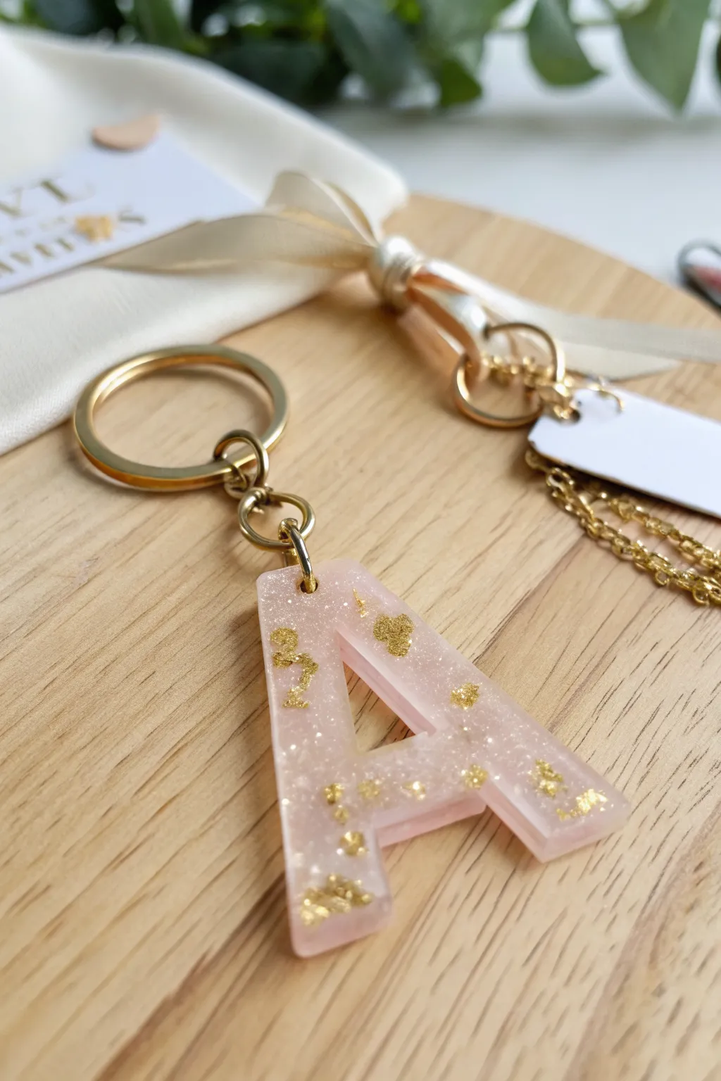 Pastel resin letter keychain styled like a minimalist boho gift set for easy epoxy project ideas.