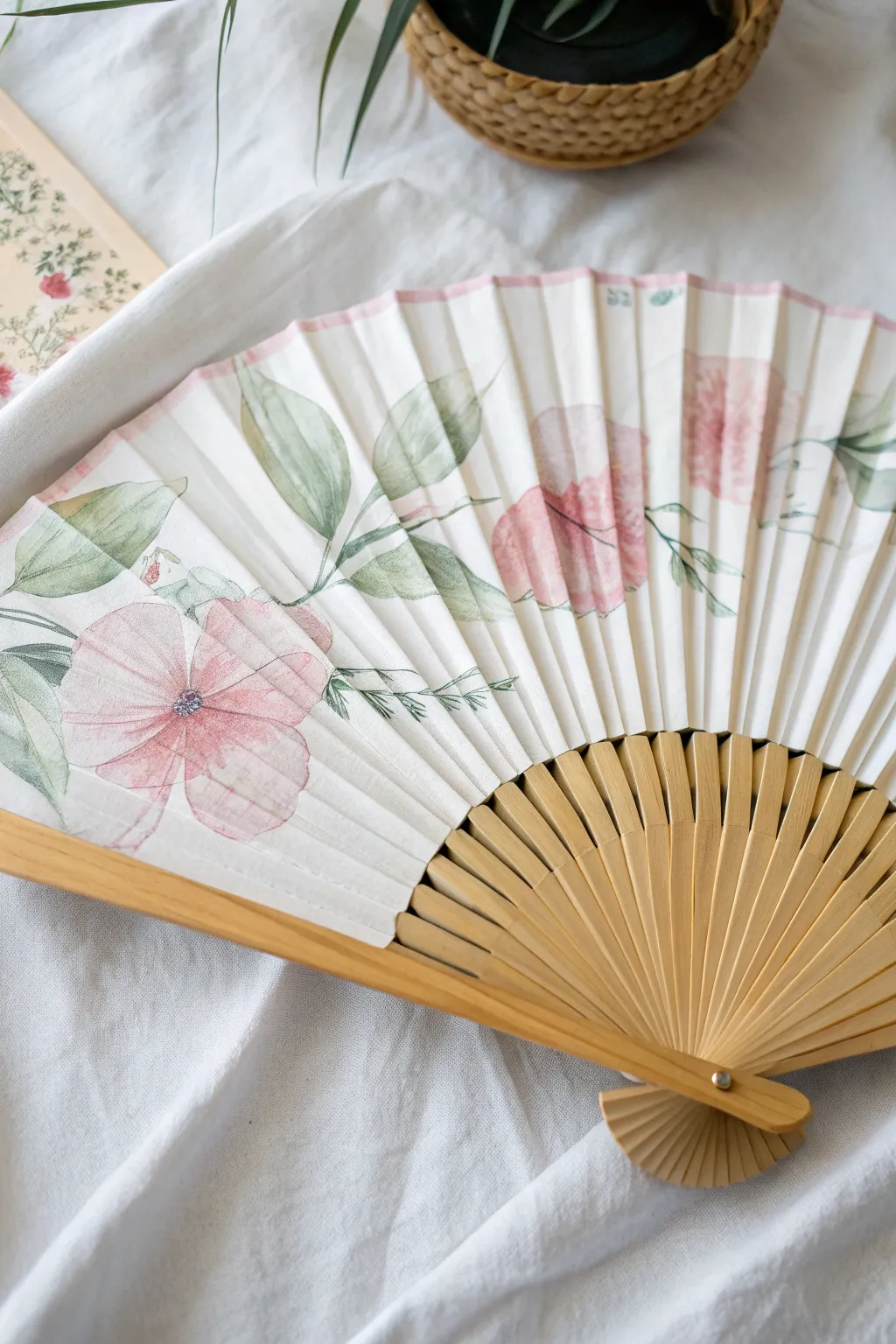 Loose watercolor peonies bloom across an open folding fan for a fresh, minimal studio-inspired look