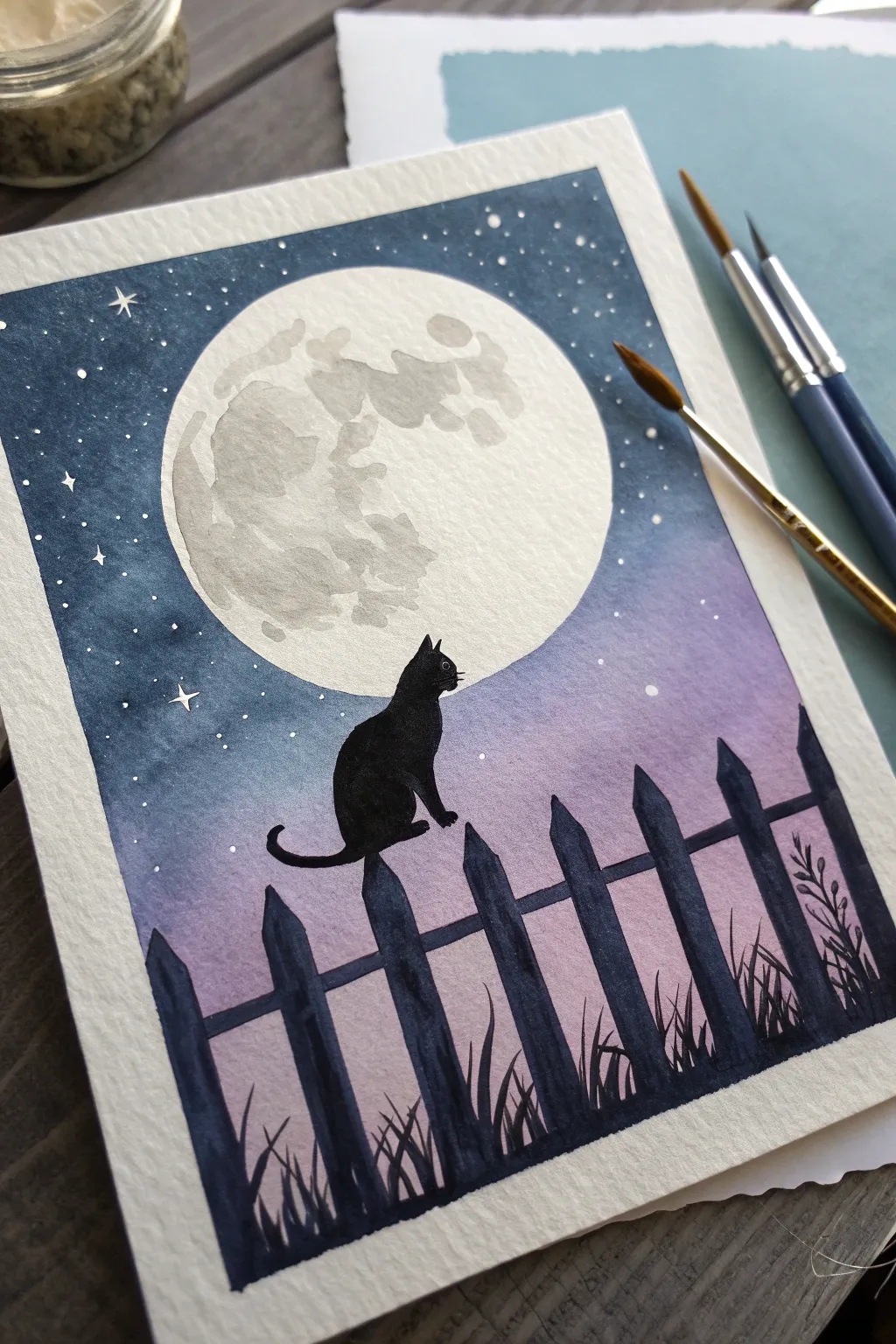 Paint a high-contrast black cat silhouette centered on a glowing full moon, perfect for Halloween.
