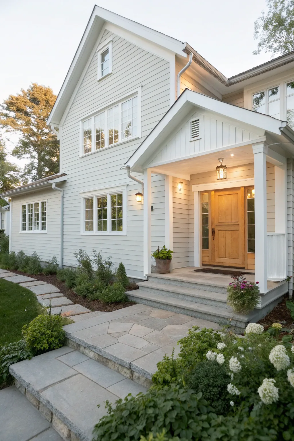 Light gray siding with bright white trim creates a crisp, airy Scandinavian curb appeal.