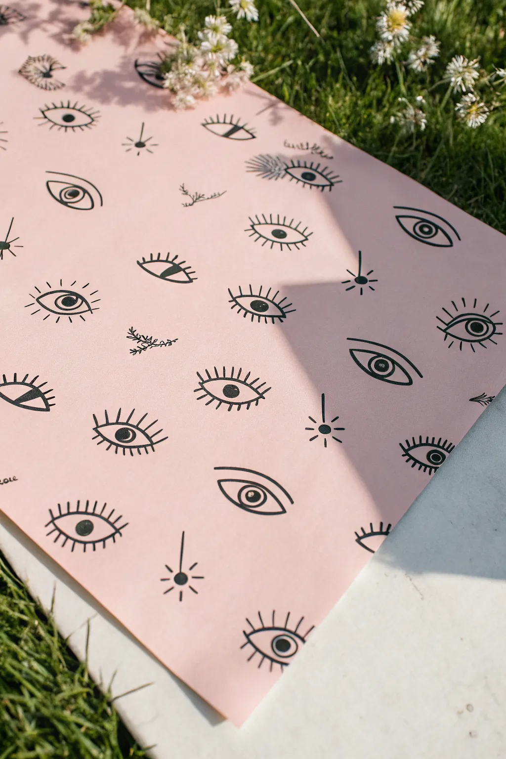 All-seeing eye doodles in bold black ink on blush paper, minimalist and easy to recreate