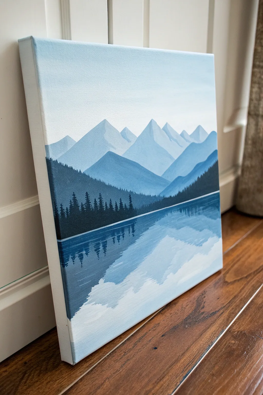 Peaceful mountain lake mirror in cool blues, a simple paint and sip canvas idea for beginners