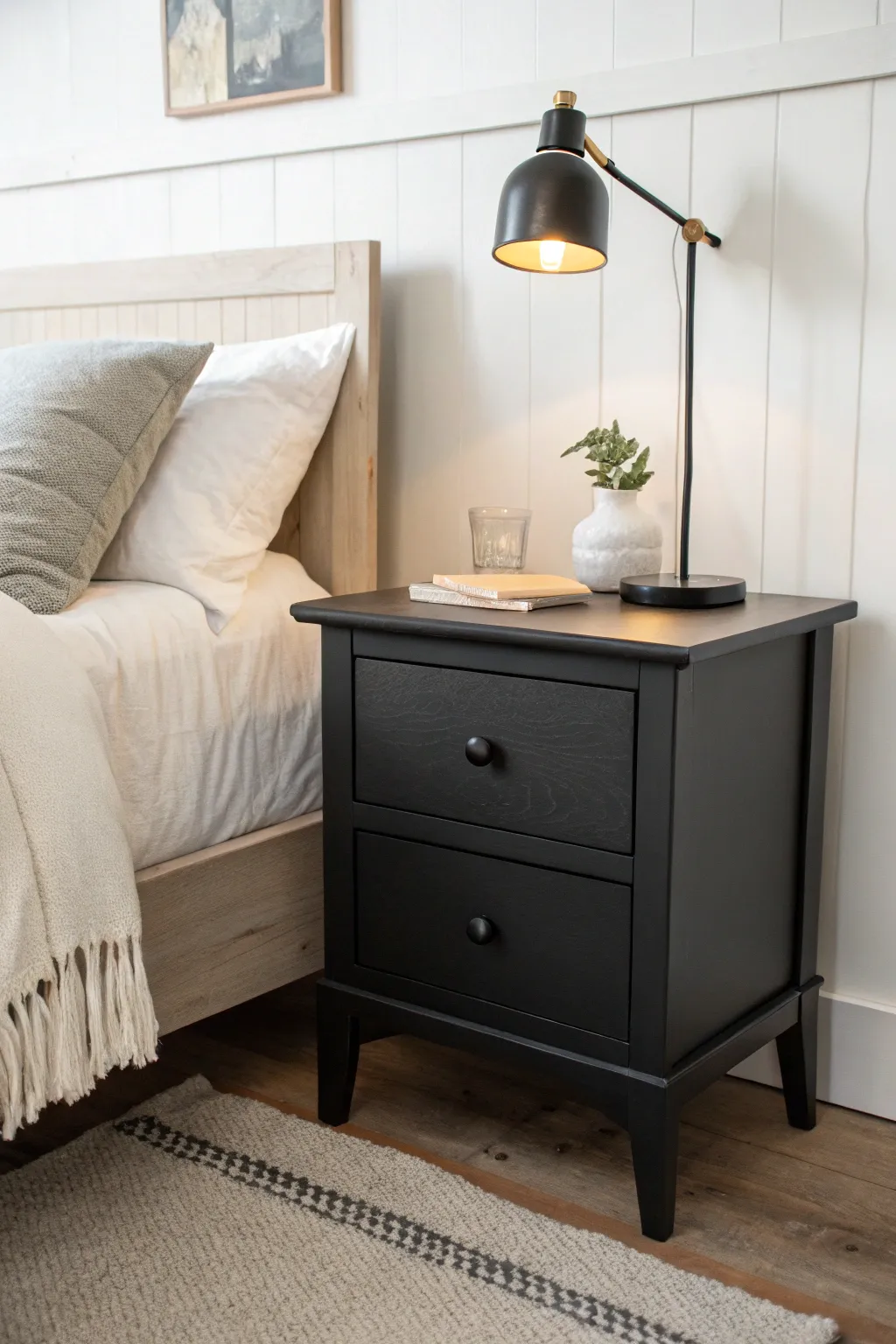 Matte black painted nightstand adds instant contrast against soft, light bedding.